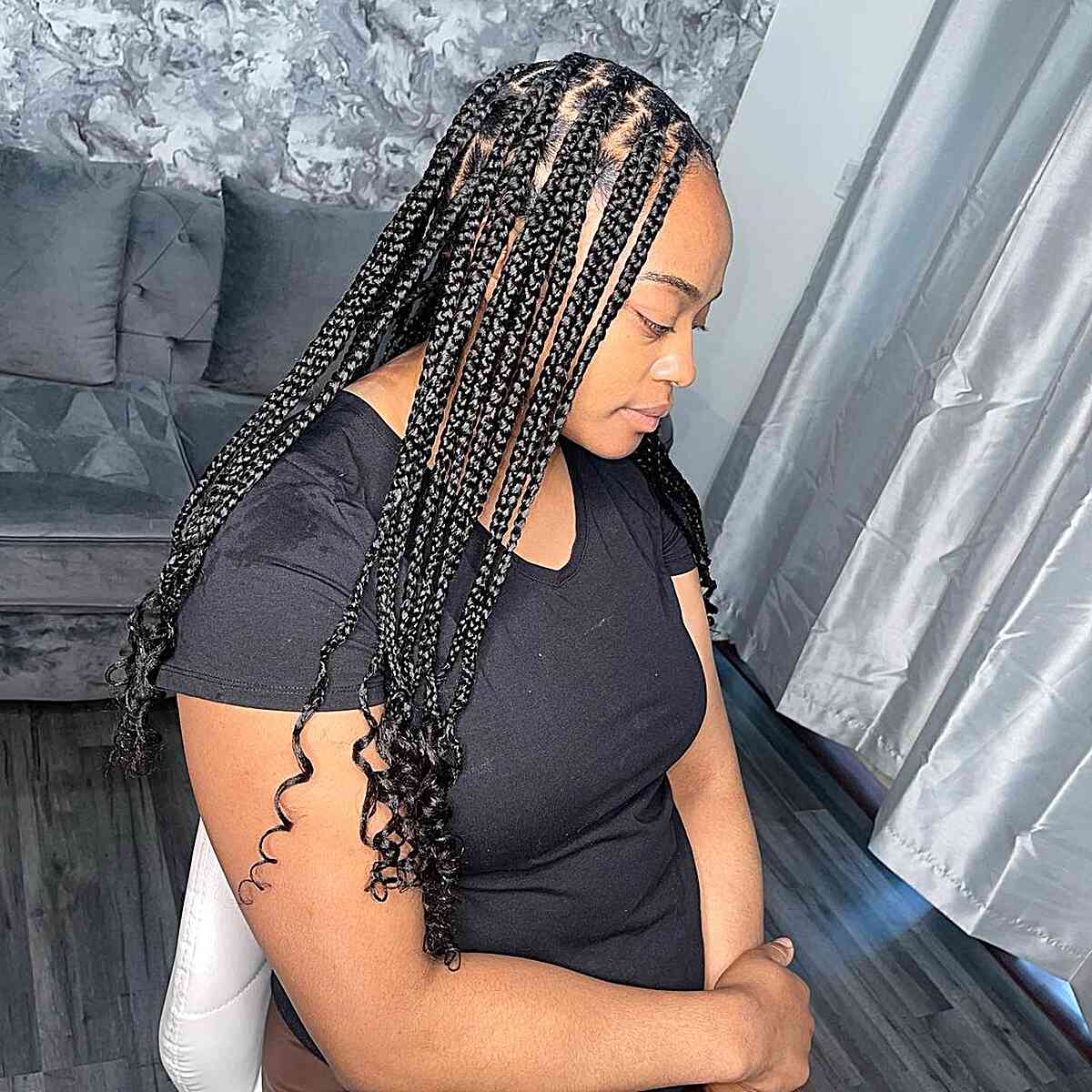 Medium length knotless braids with cascading curls