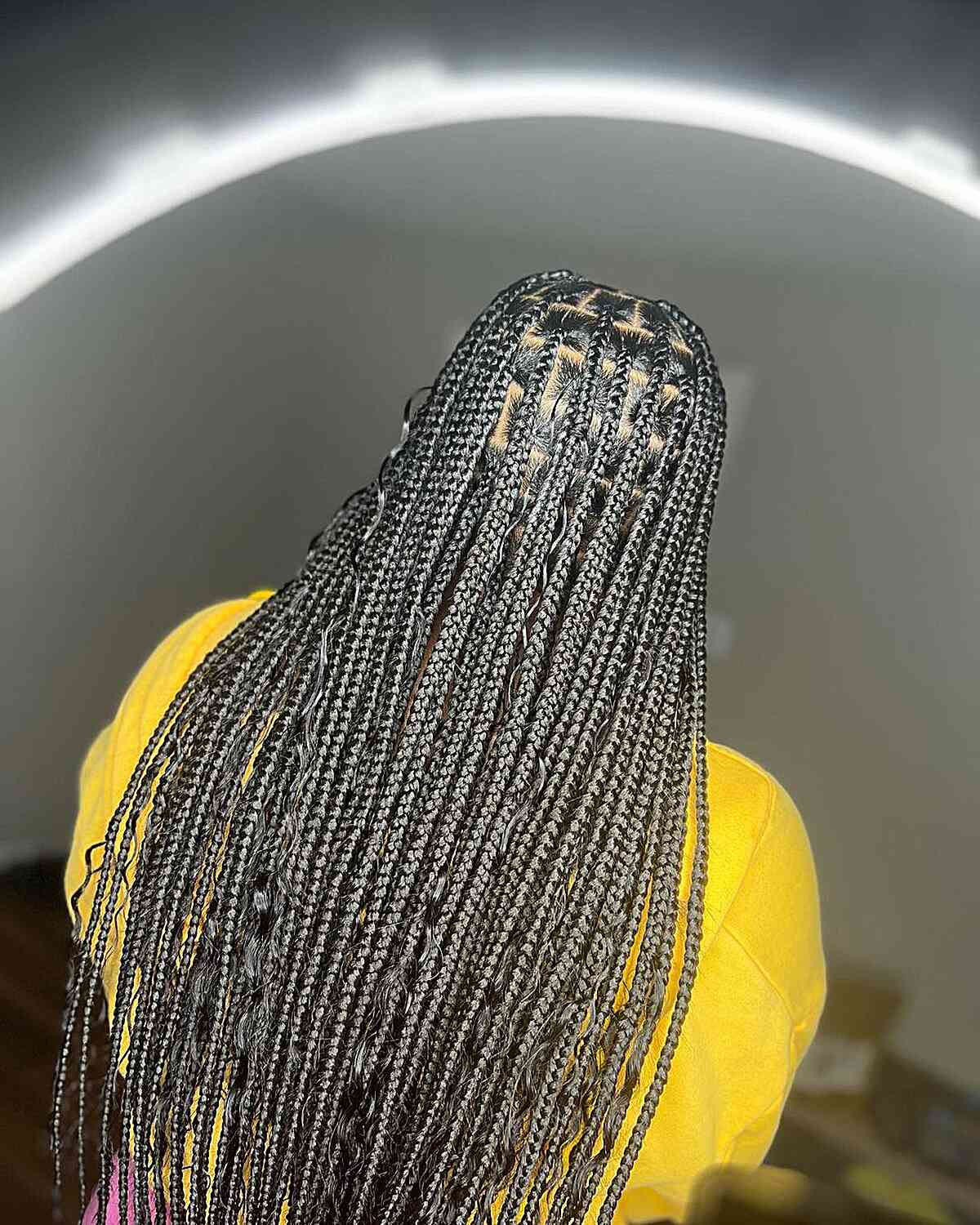 Medium length knotless box braids with loose curls