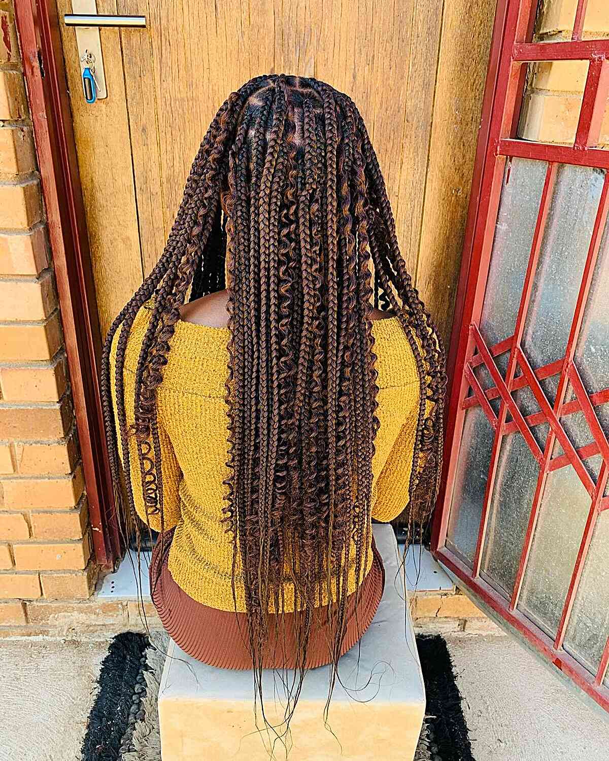 Medium sized braids without knots along the nape with curls for brown hair