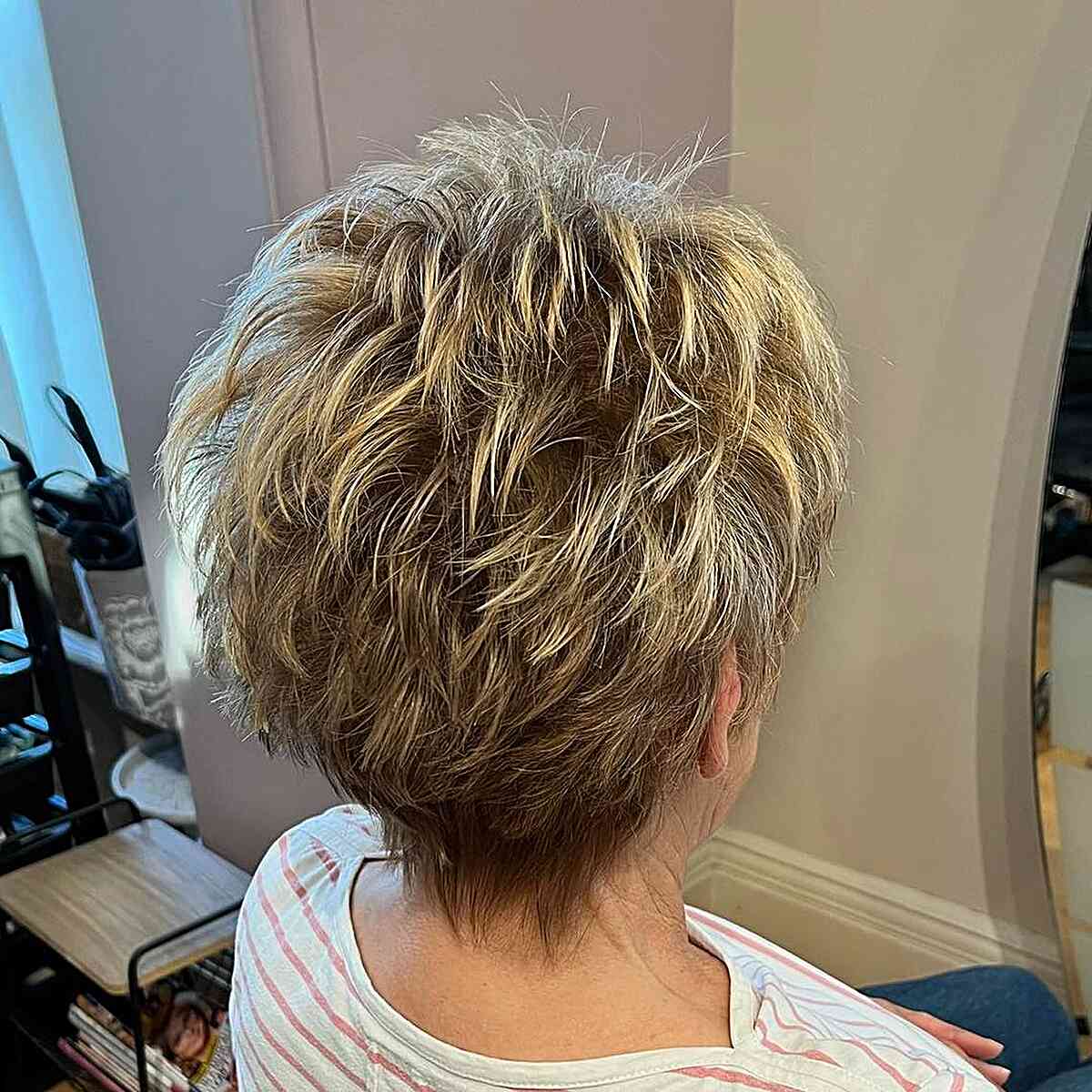Dark-Rooted Blonde Feathery and Choppy Pixie for Mature Women Aged Sixty