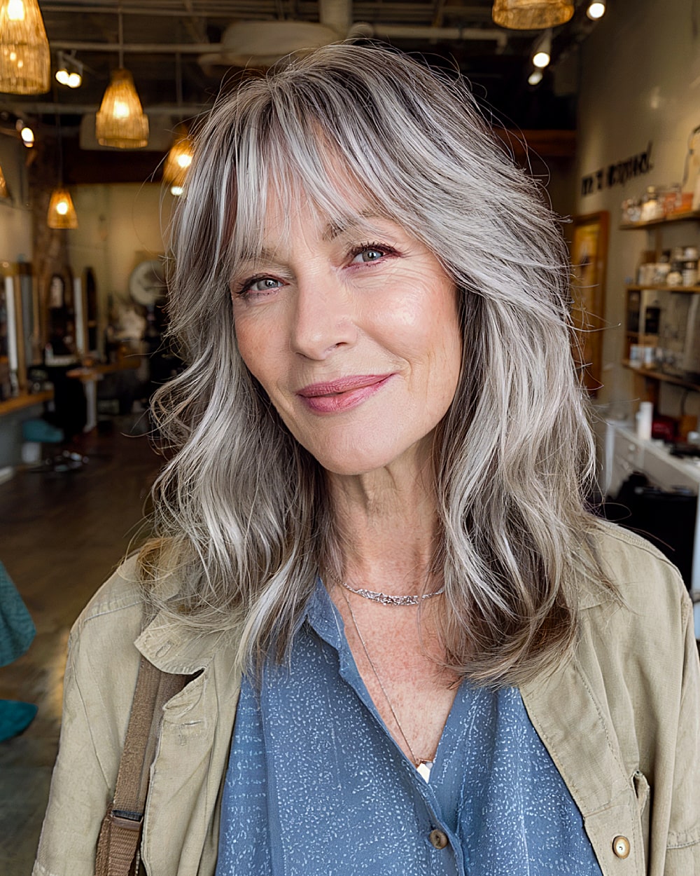 Medium length layered shag with bangs for women over 60 with silver hair