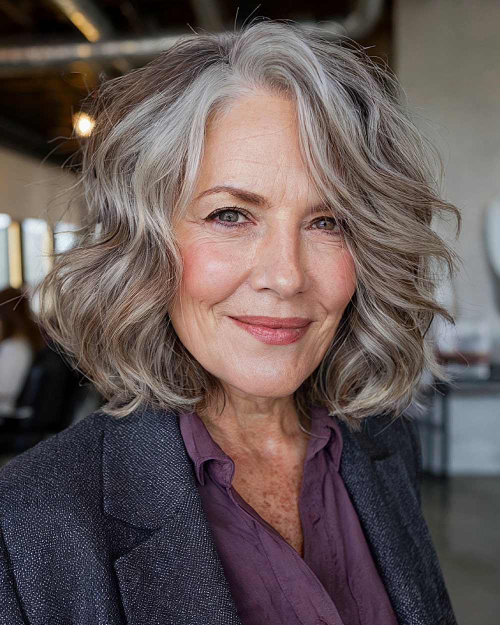Layered wavy lob with side part for women over 60 with gray highlights