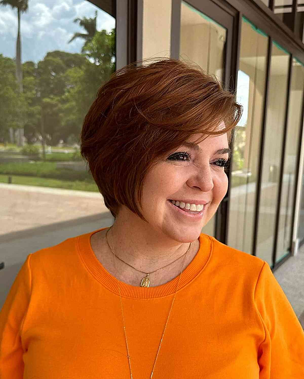 Pixie bob with a deep side part on women with thick hair over the age of 60