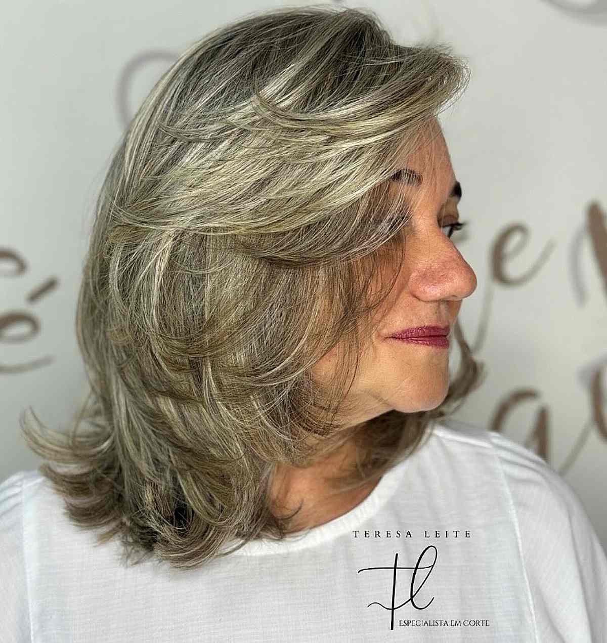 Thick, shoulder-length gray haircut for women over 60