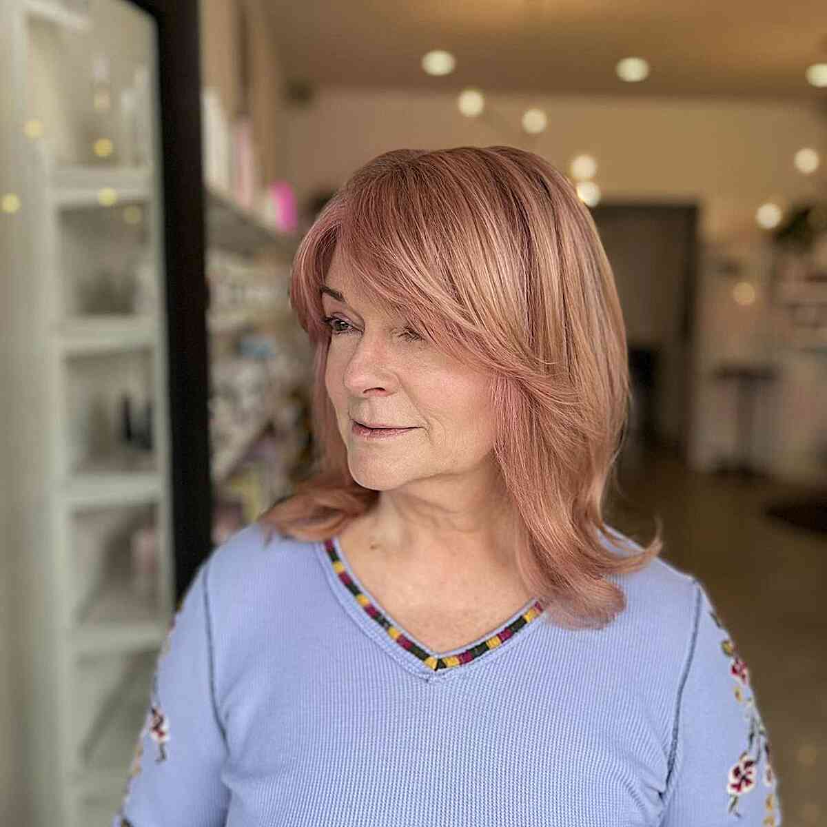 Medium length peach thick hair with curtain bangs for 60 year old women