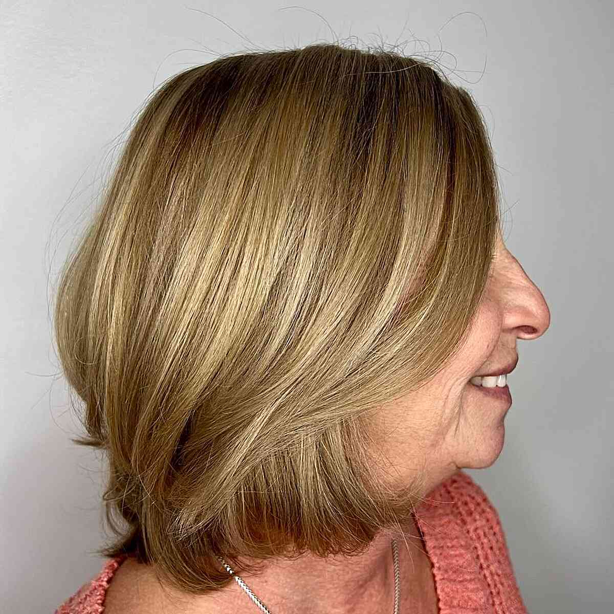 Long, sunny bob with layers mixed with thick, 60-year-old hair