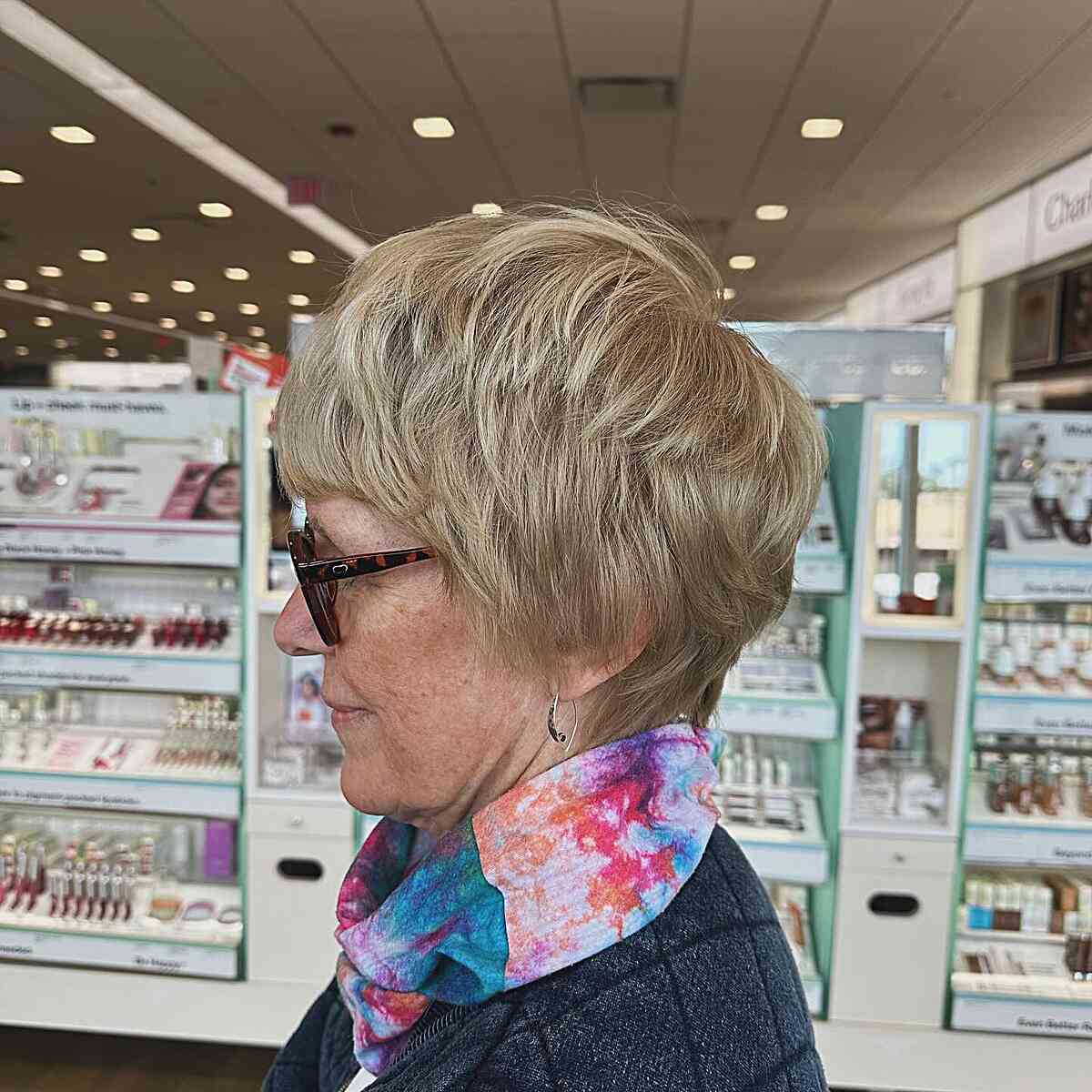 Thick pixie hair with choppy layers for older women over 60 with glasses
