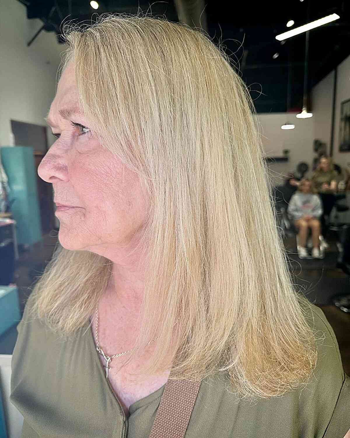 Coarse and thick blonde hair of medium length for older women over 60 years