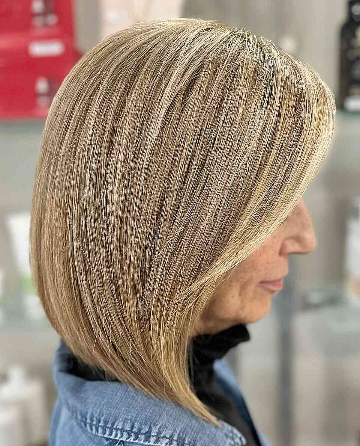 Stylish angled lob haircut for 60 year old women with a thick mane