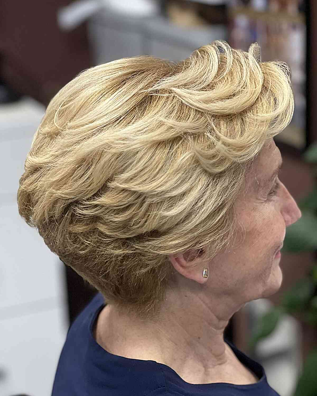 Swoopy short layered blonde pixie for a 60 year old with coarse hair