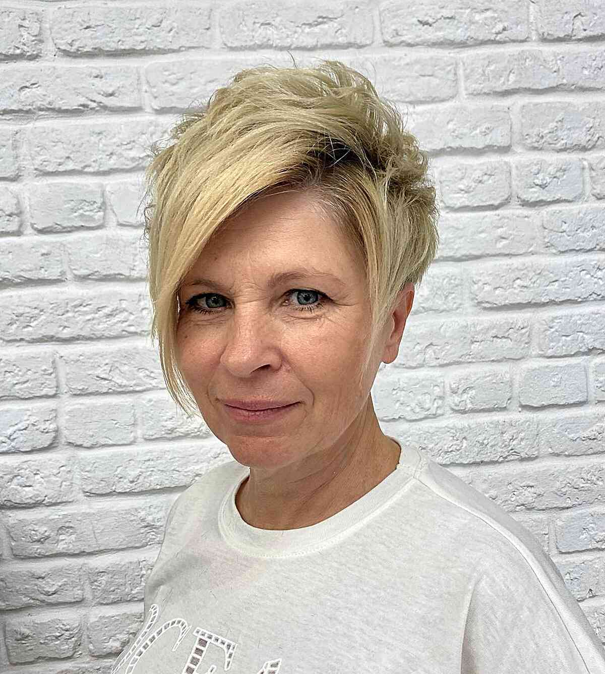 Short tight pixie with side bangs for 60 year olds with thicker locks