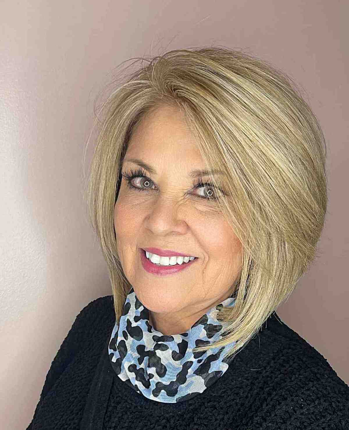 Voluminous bob for older women over 60 with straight, neck-length hair and round faces 