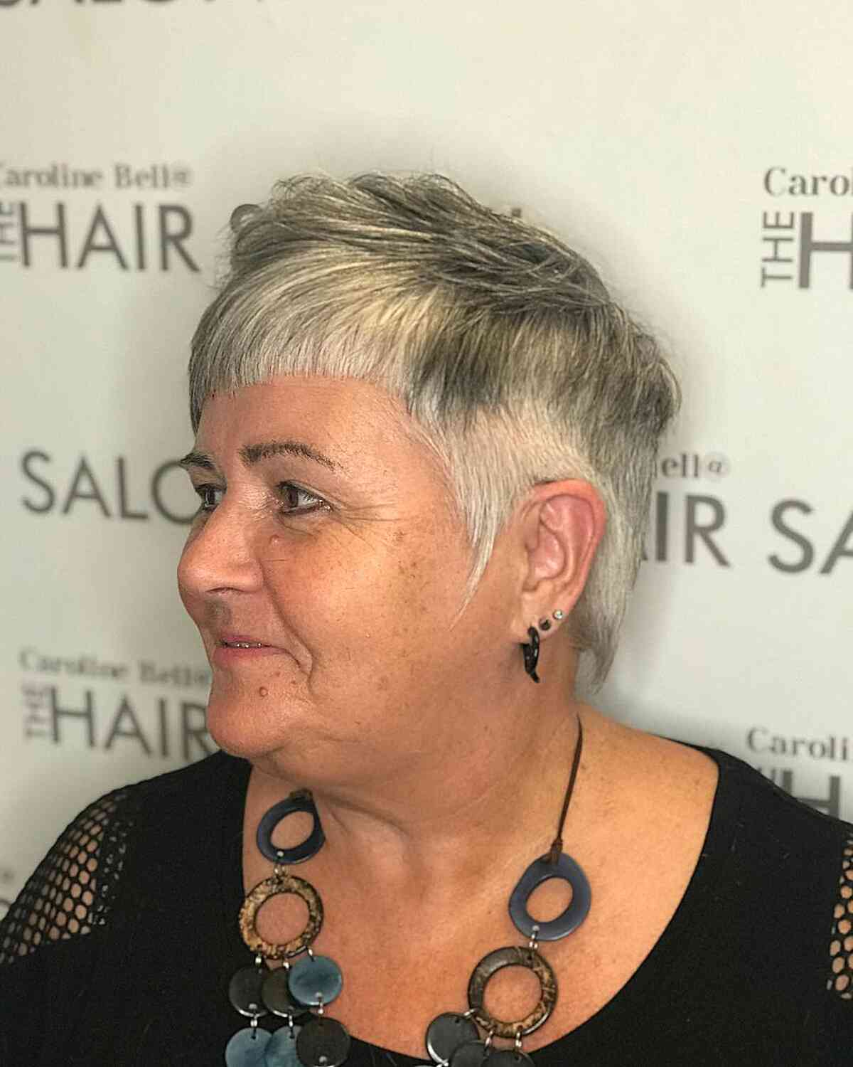 Pixie haircut with short bangs for women over 60 with full faces