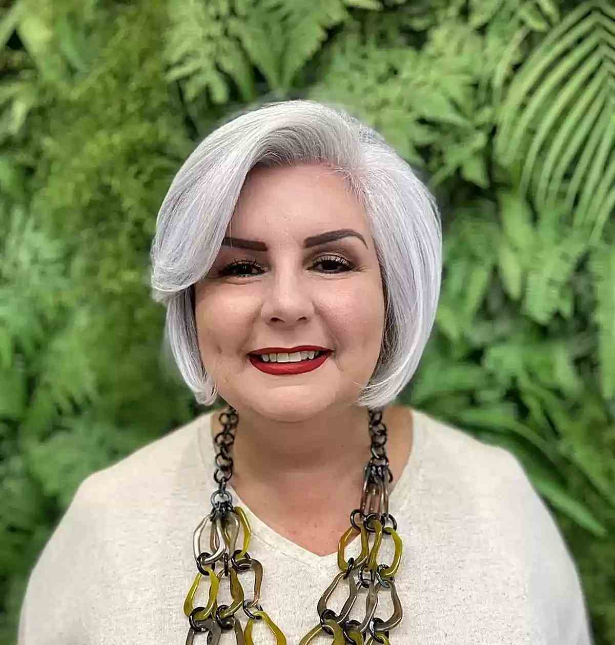 Gray chin bob with side bangs is on older women over 60 with round faces