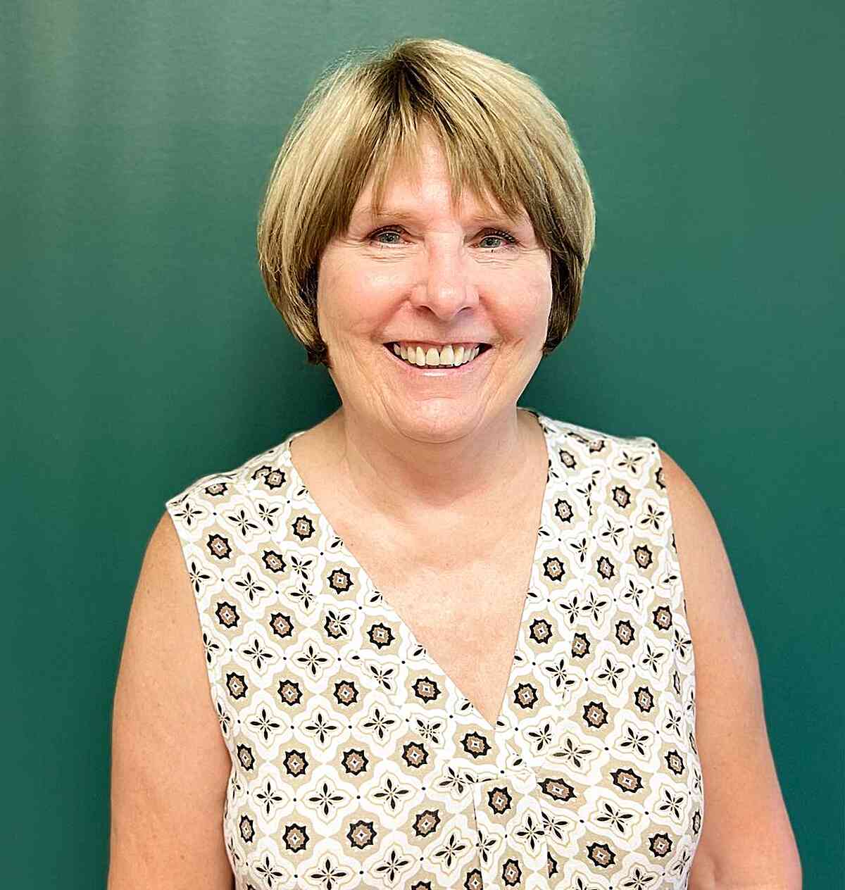 Jaw length blonde hair with side bangs for older women 60+ with round faces