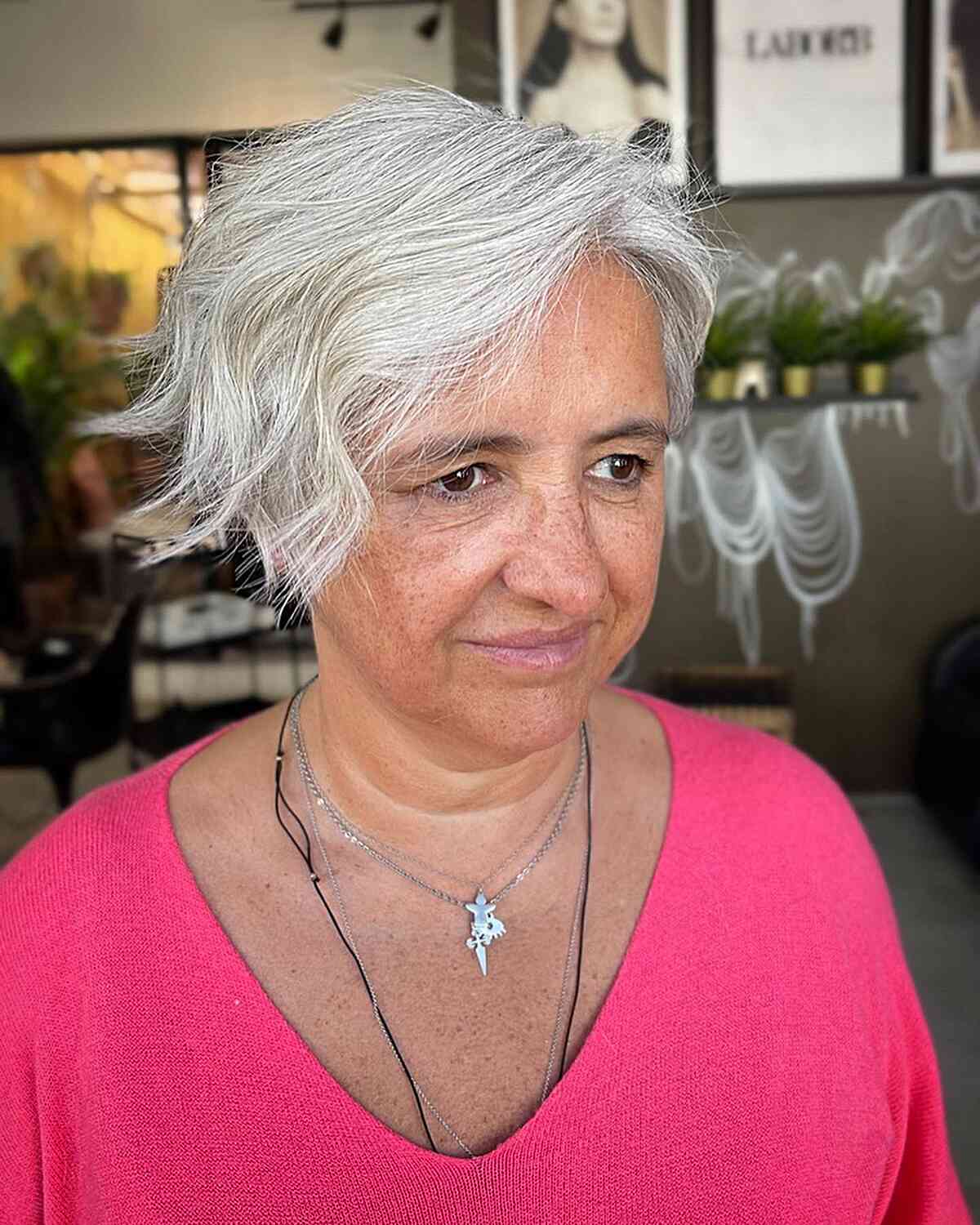 Long pixie cut with side parts with waves for seniors over 60 and round face shapes