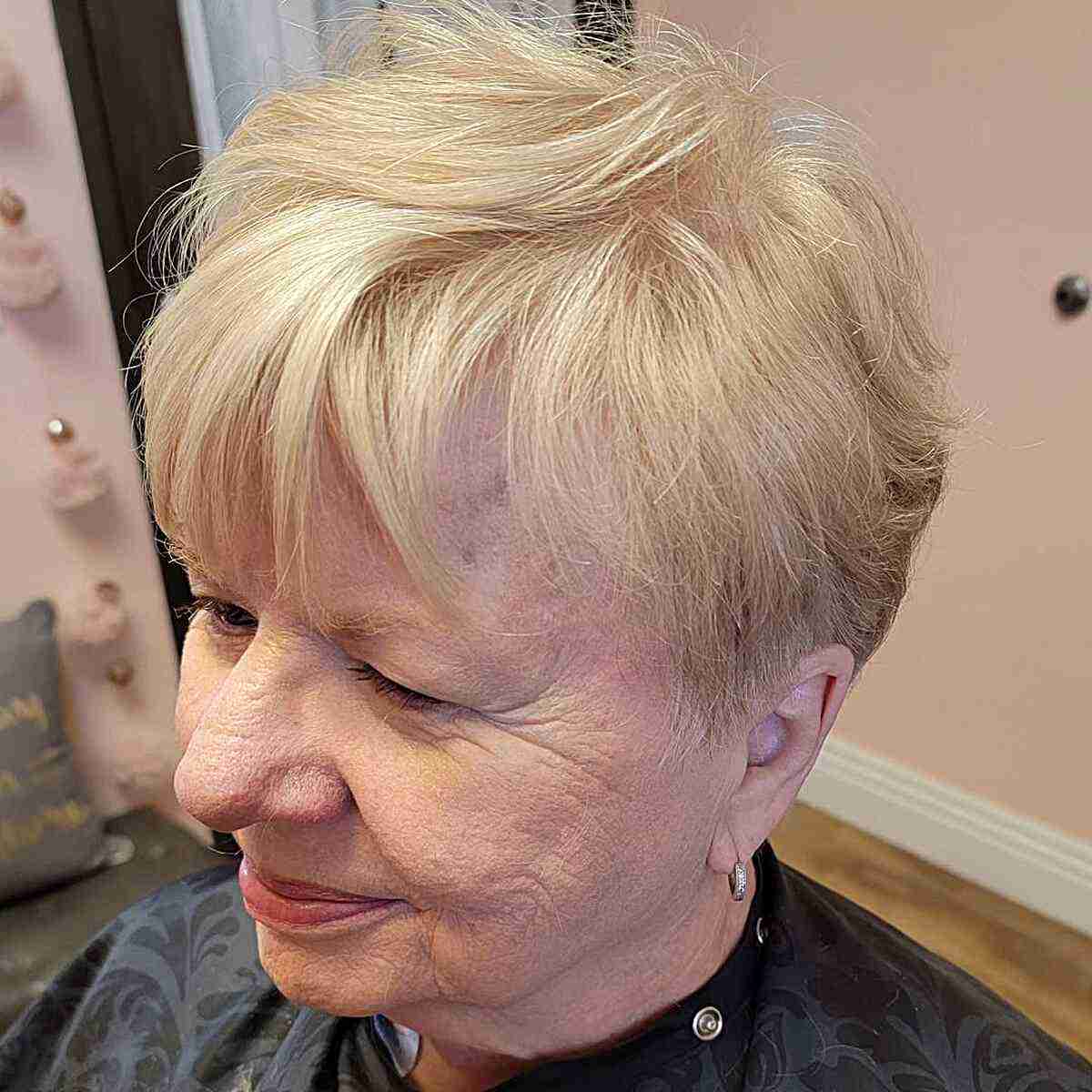 Feathery blonde pixie with bangs is for seniors over 60 with round faces