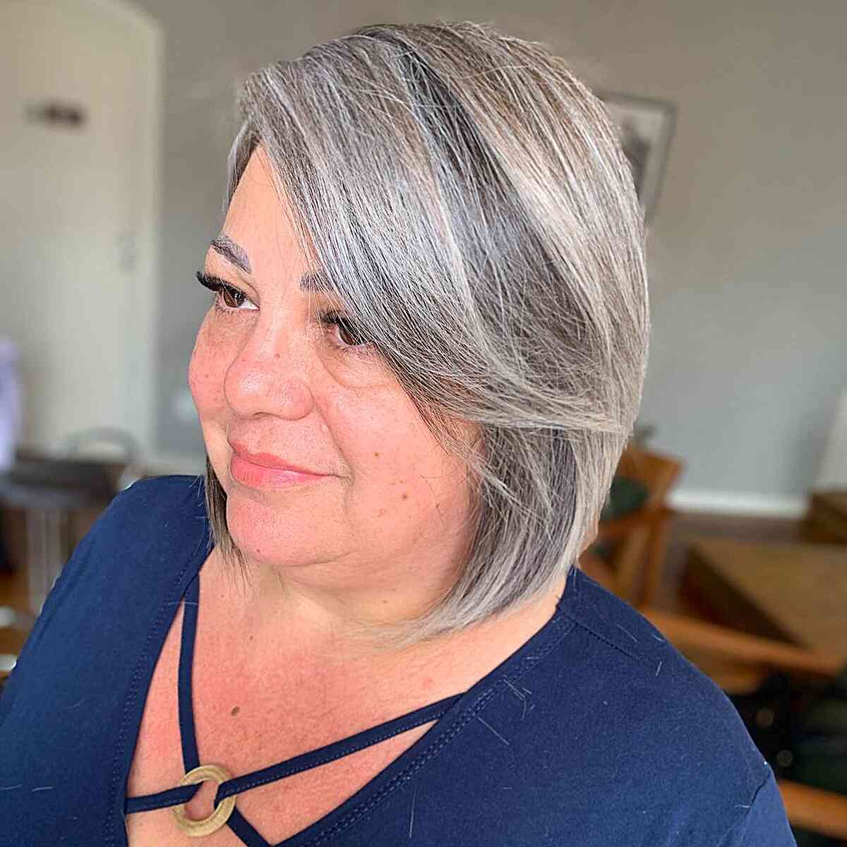 A classic, elegant neck-length bob on thick-haired older women in their 60s with full faces