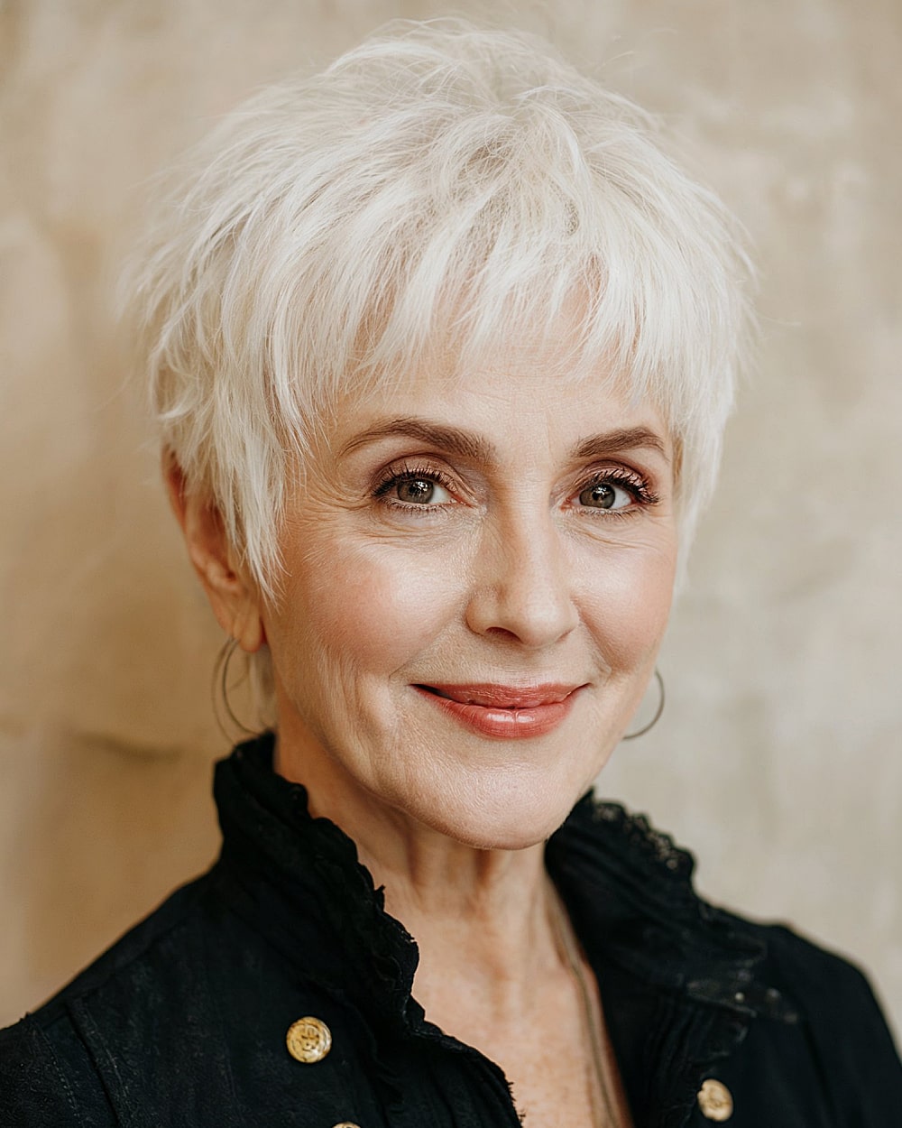 Short textured pixie for women over 60 with layered crown and wispy fringe
