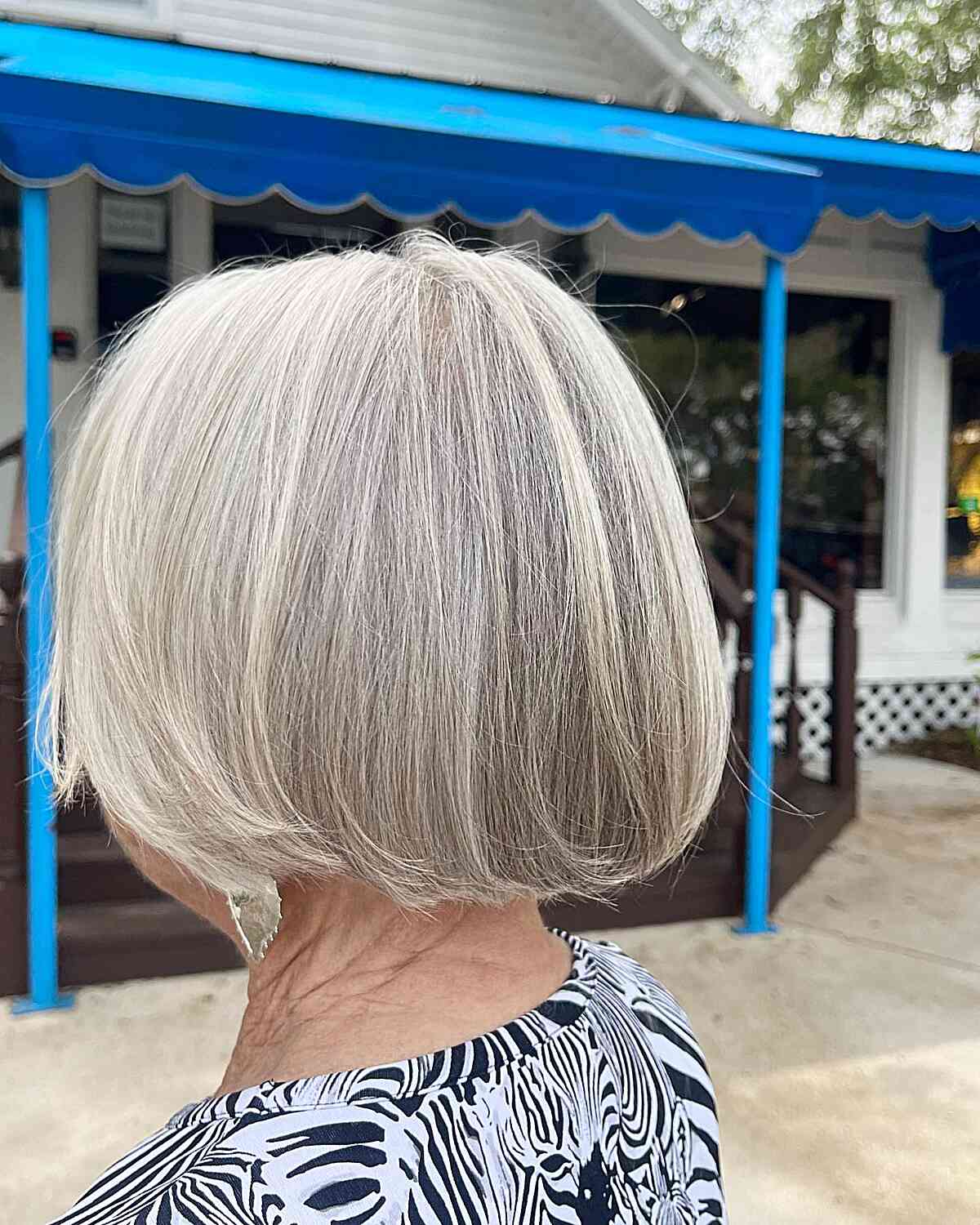 Classic jaw-length silver cut with soft layers for seniors over 60