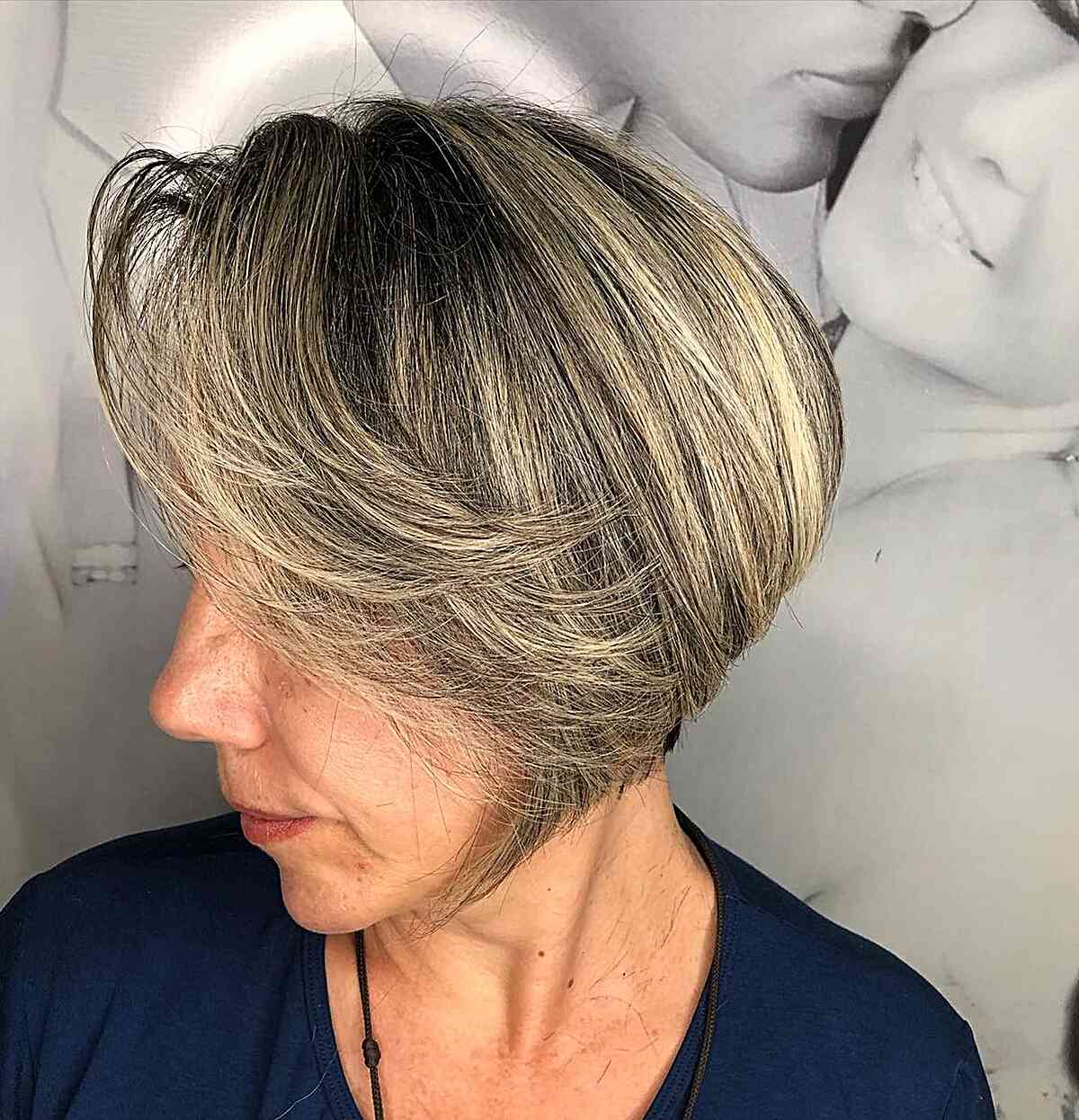 Jaw-length blonde bob with long side bangs and stacked layers for older women over 60