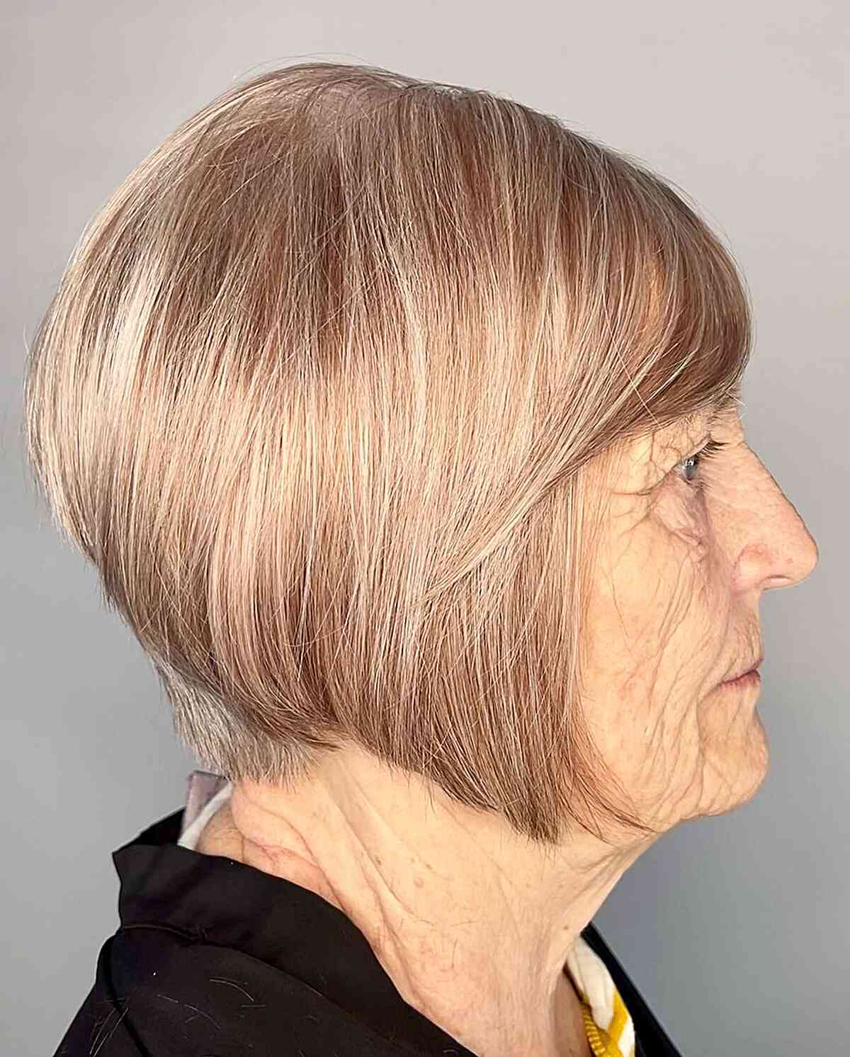 A very short A-line bob with bangs and a pointed nape for older women over 60