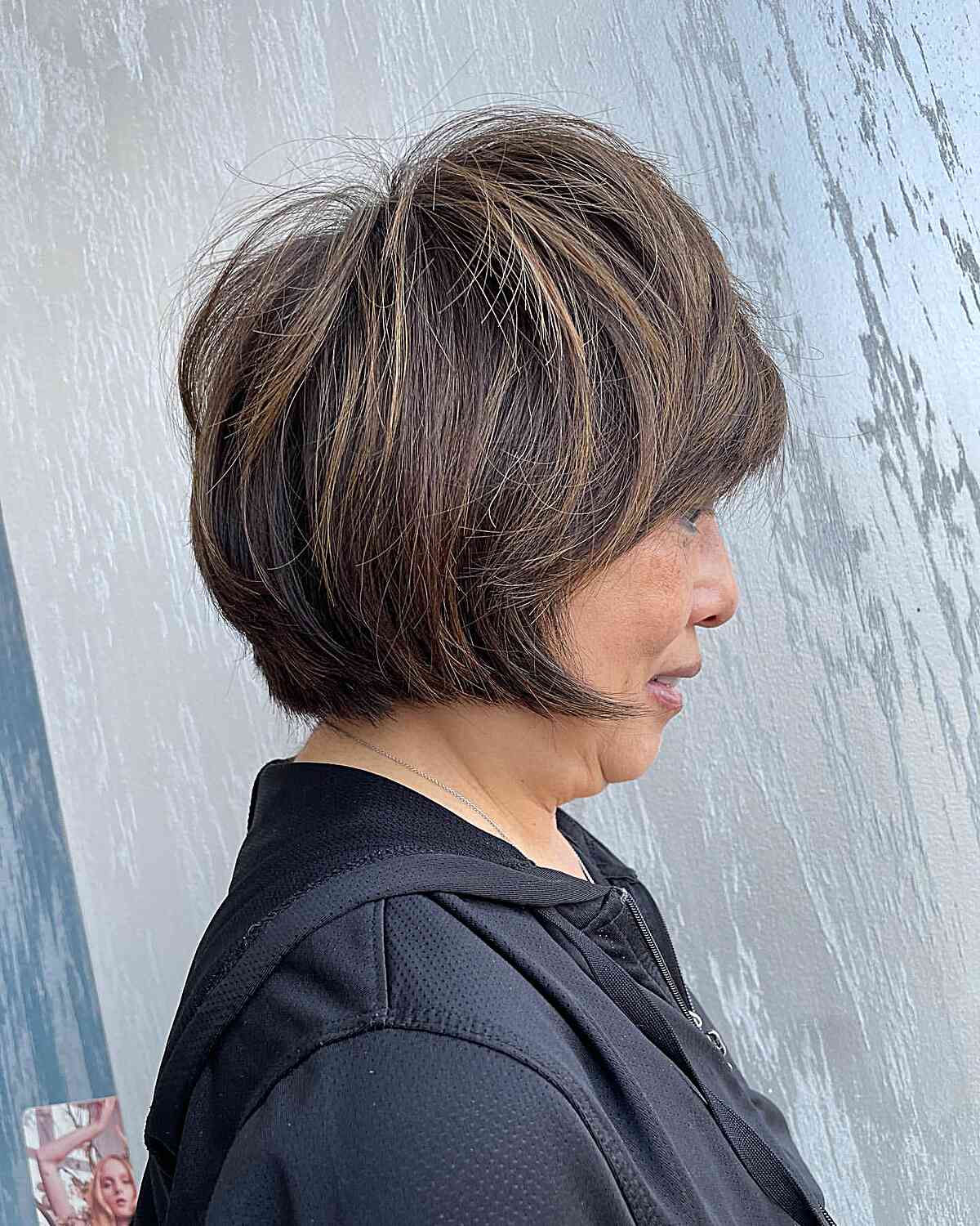 Jaw-length straight shaggy bob with crown layers for mature women over 60 with blonde hair