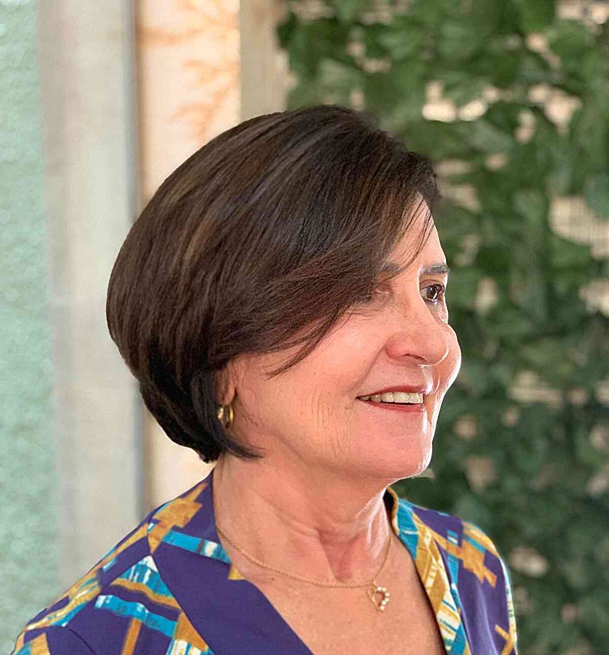 Short and soft thick inverted bob with side fringe for women over 60 years old