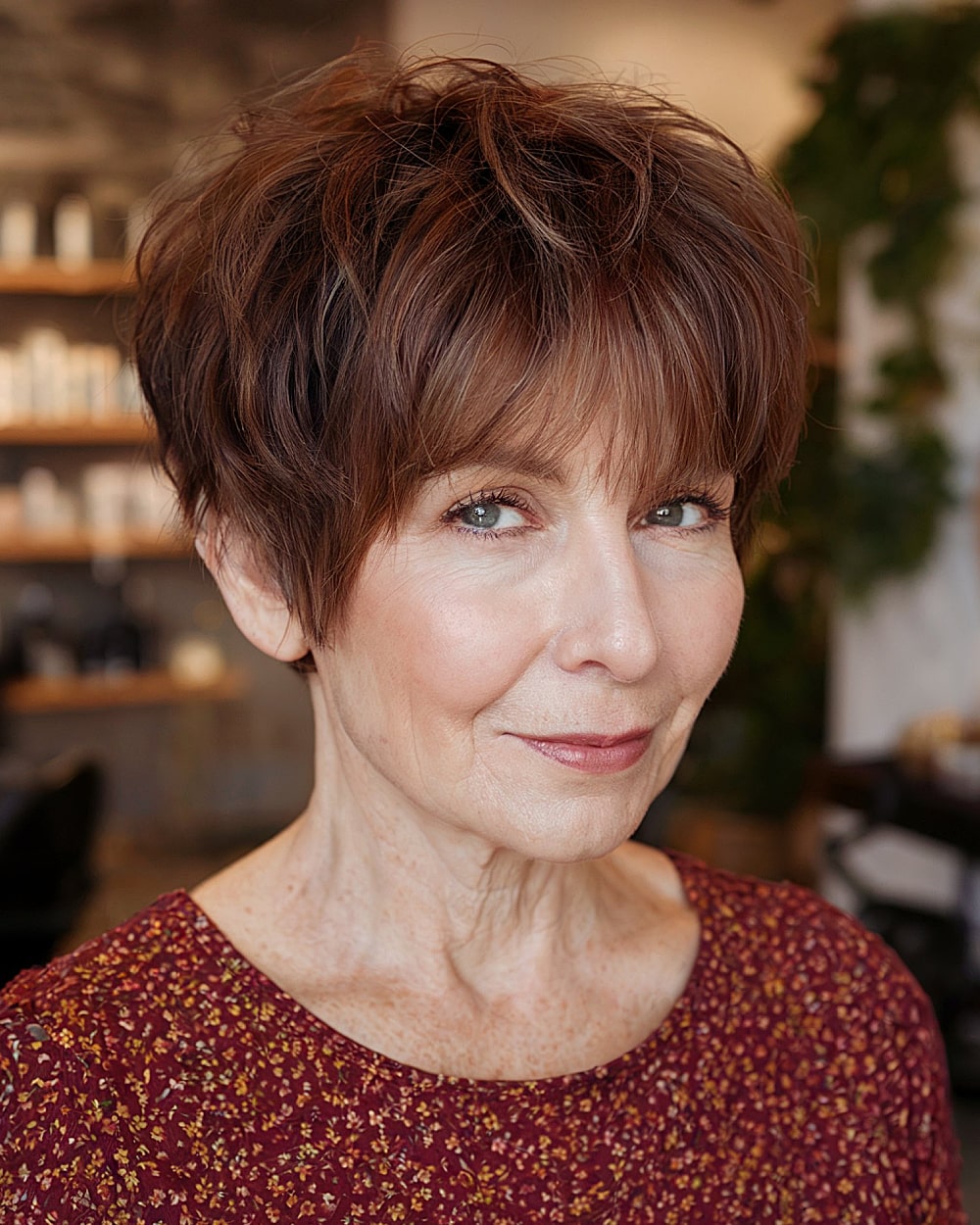 Pixie shag with choppy texture and brow-length bangs for older women with fine hair