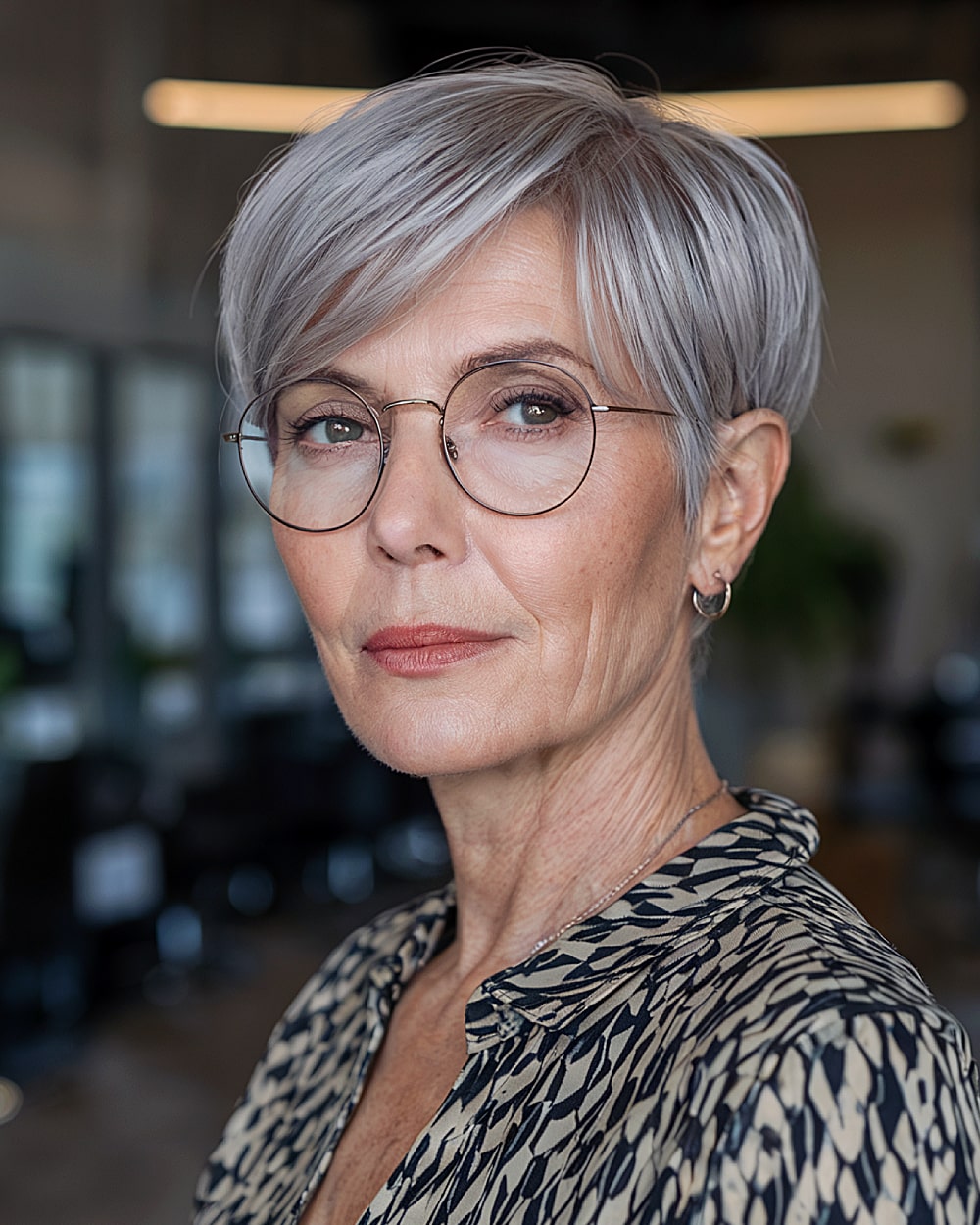 Sleek long pixie hairstyle with deep side part and tapered back for stylish older women