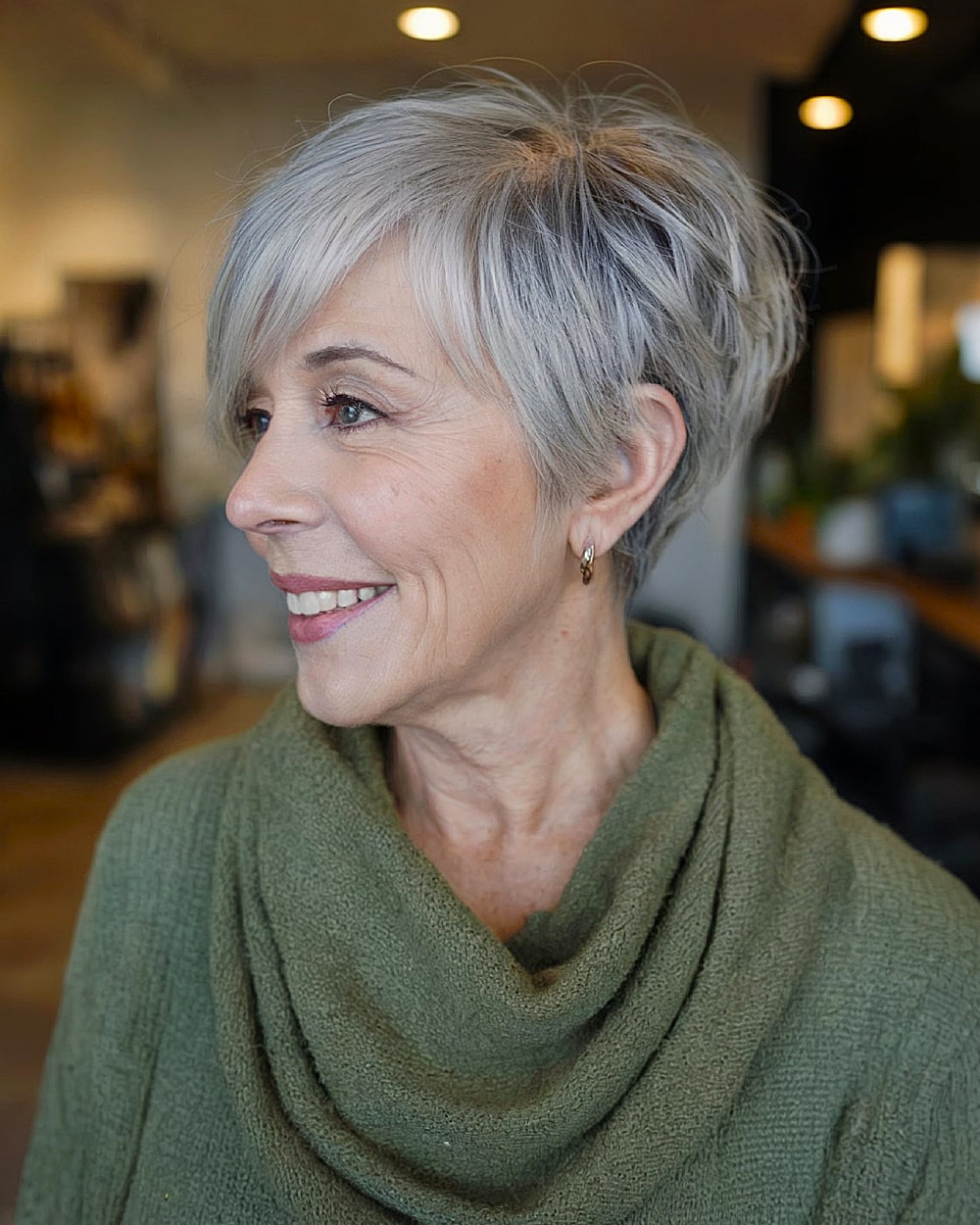 Tapered long pixie cut with side-swept layers and soft gray blending for mature women