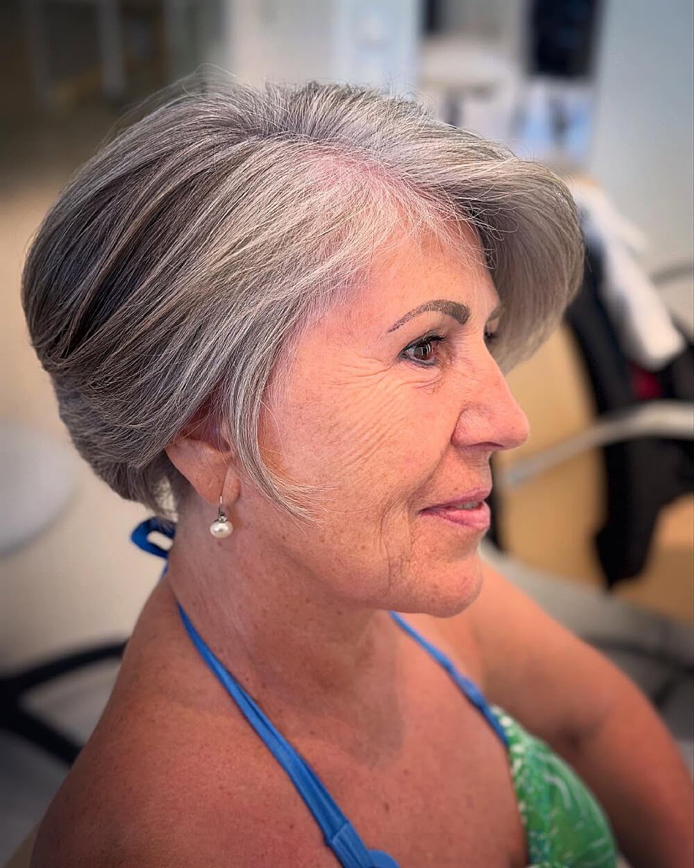 Side-volume tapered silver pixie for women over 60 with short, natural-textured gray hair