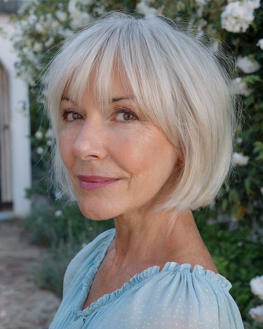 Light platinum gray bob with fringe bangs for women over 60