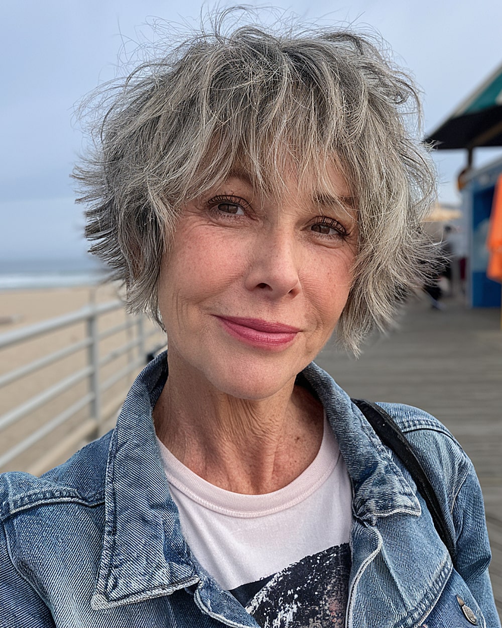 Short shaggy hair with natural gray highlights for mature women