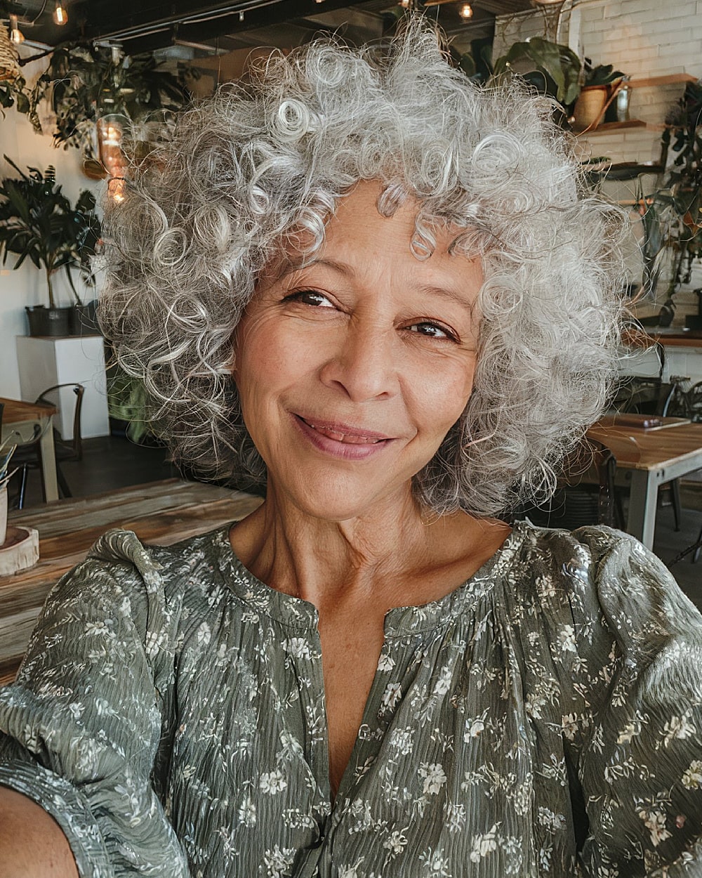 Short and voluminous gray curls of round shape for women over 60 years old