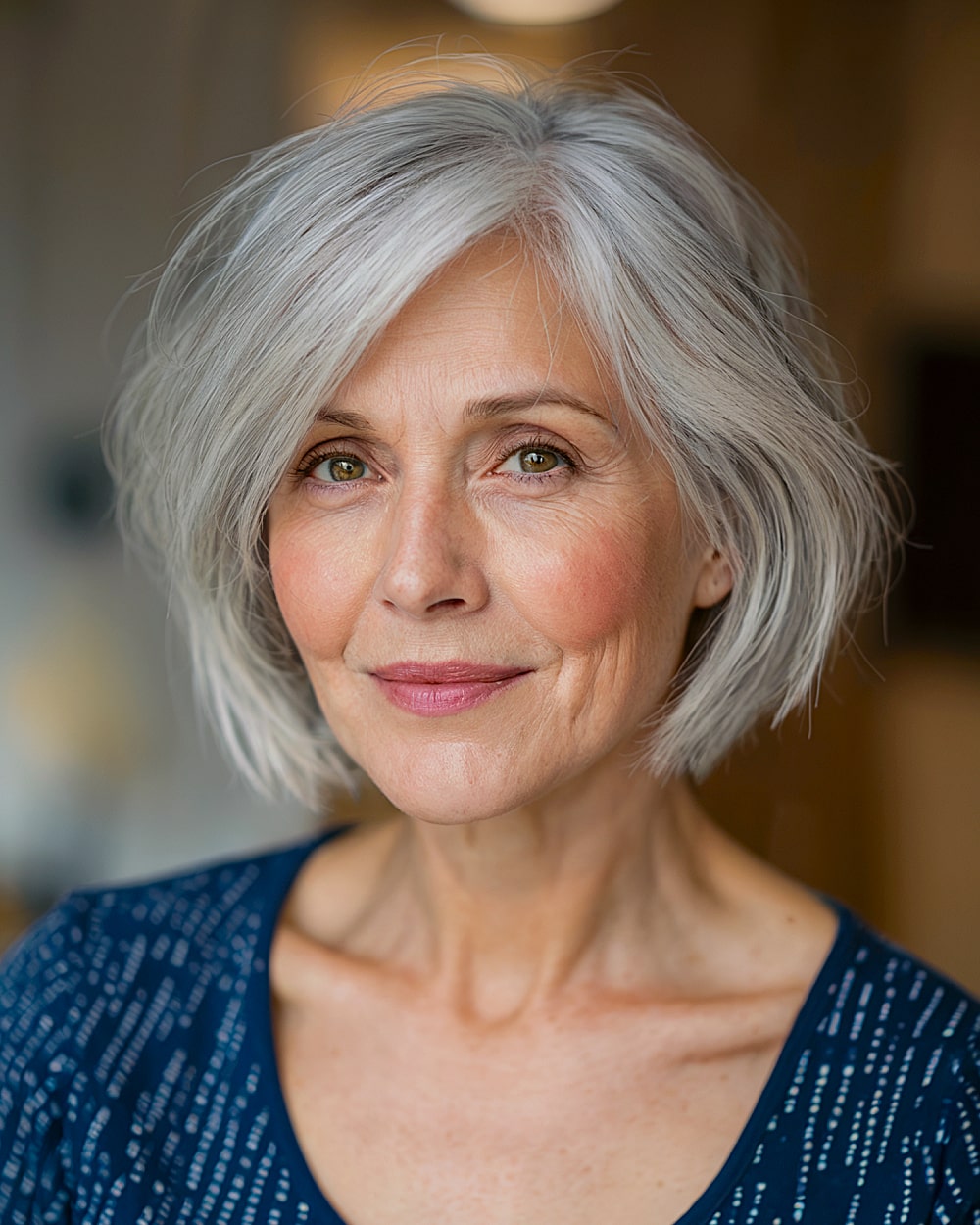 Soft layered bob for gray hair over 60 with side bangs and face-framing volume
