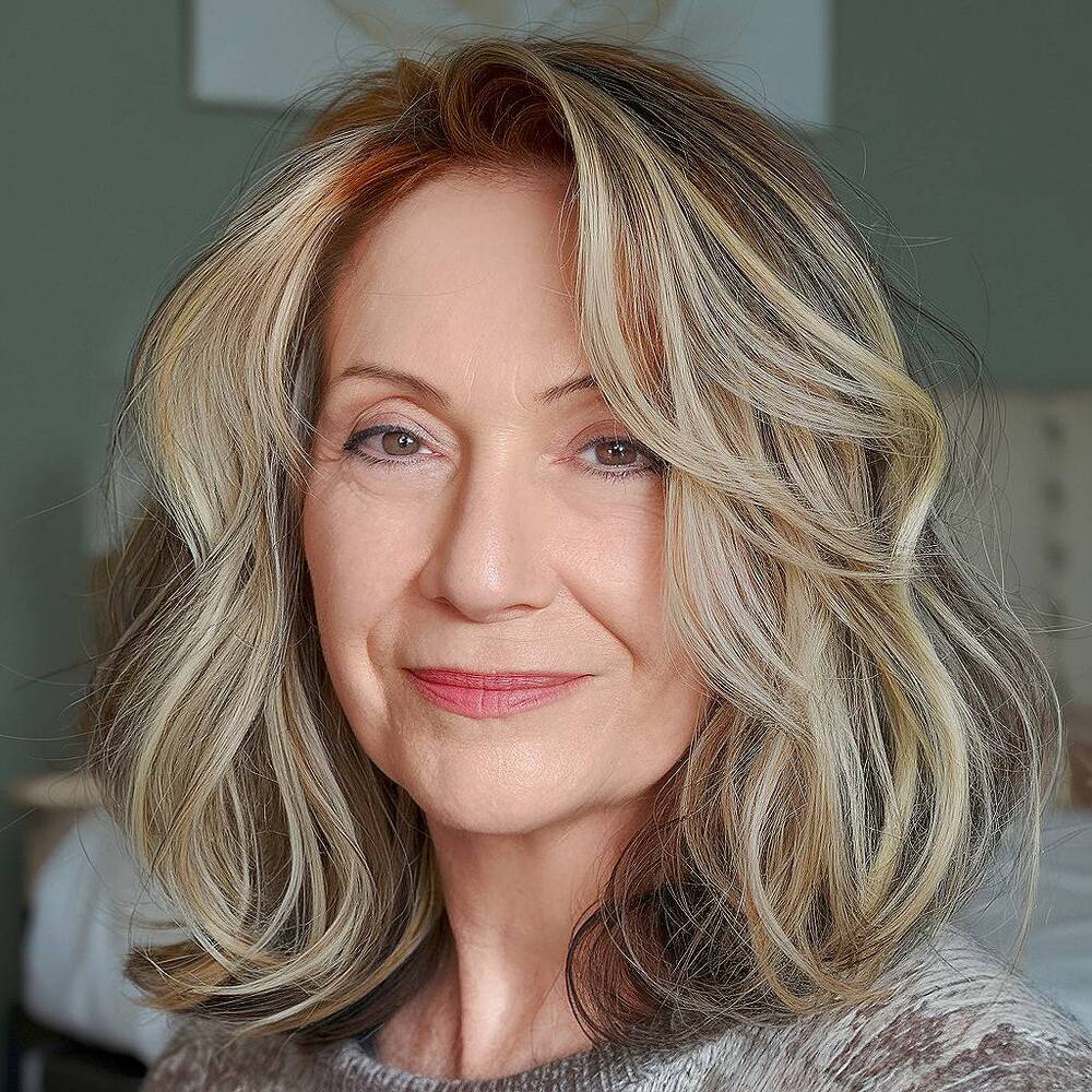 Shoulder-length wavy hair with highlights adds brightness and movement for women over 60
