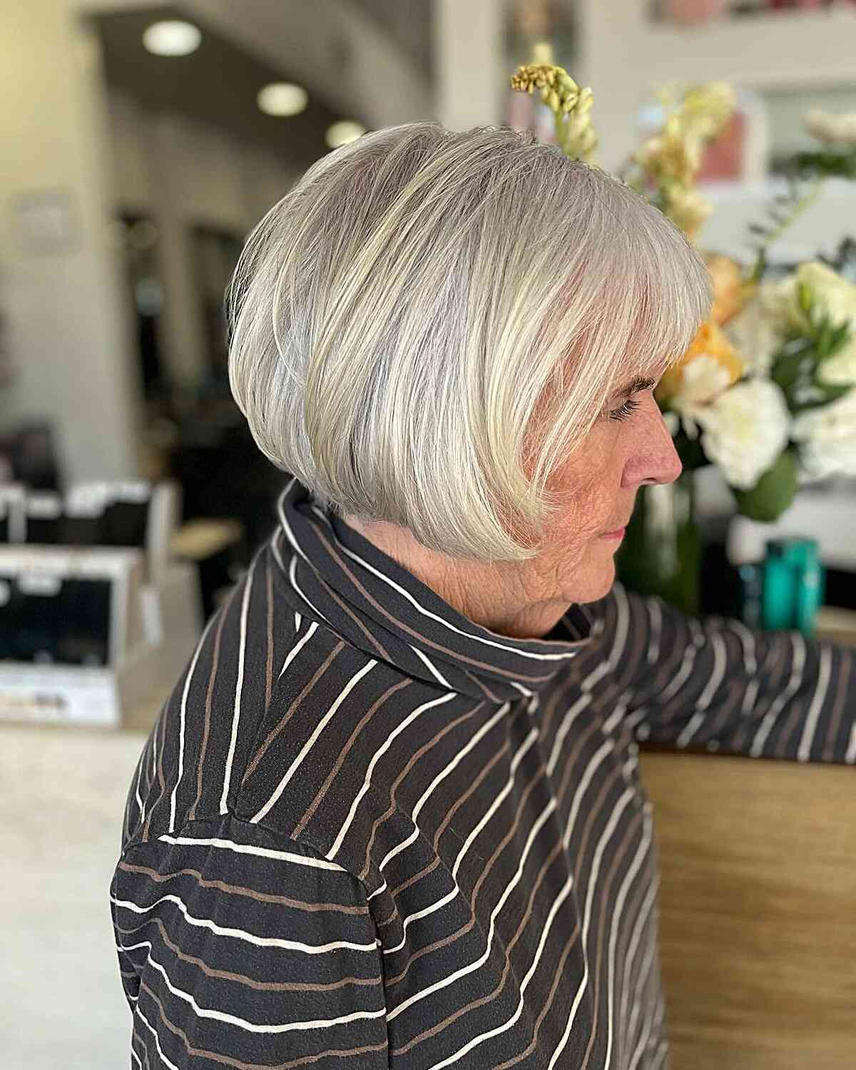 Short length French bob with bangs for older women in their 60s