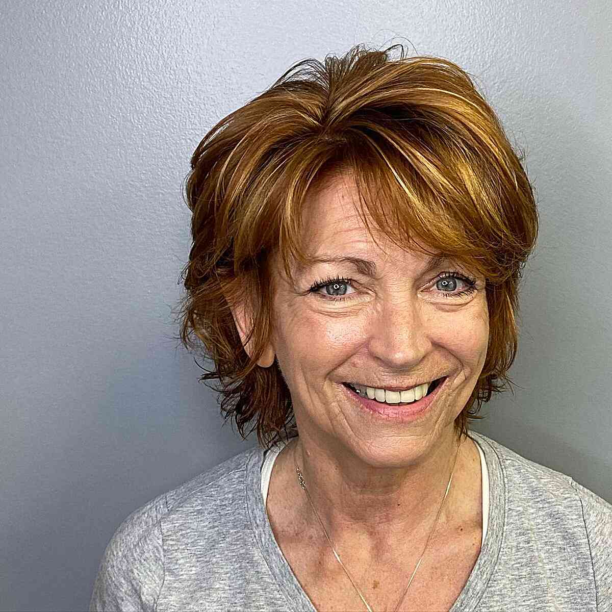 Short dimensional hair with swoopy bangs for women over 60 and up