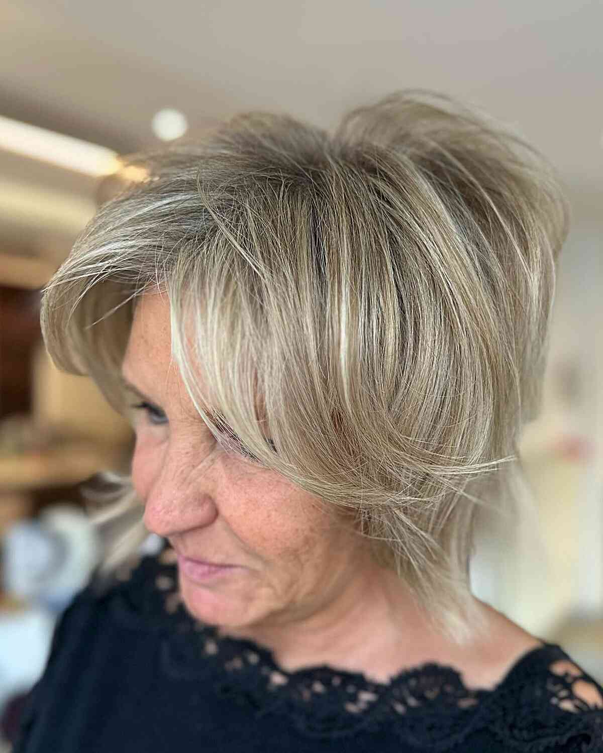 Short stacked hair with long bangs for women in their 60s