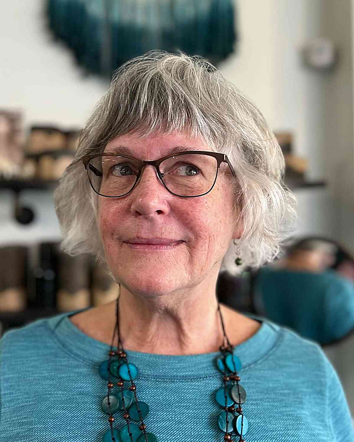 Jaw-length wavy hair with choppy bangs in 60 year old women