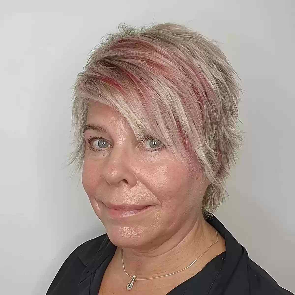 A choppy blonde pixie with red highlights and bangs on 60 year olds