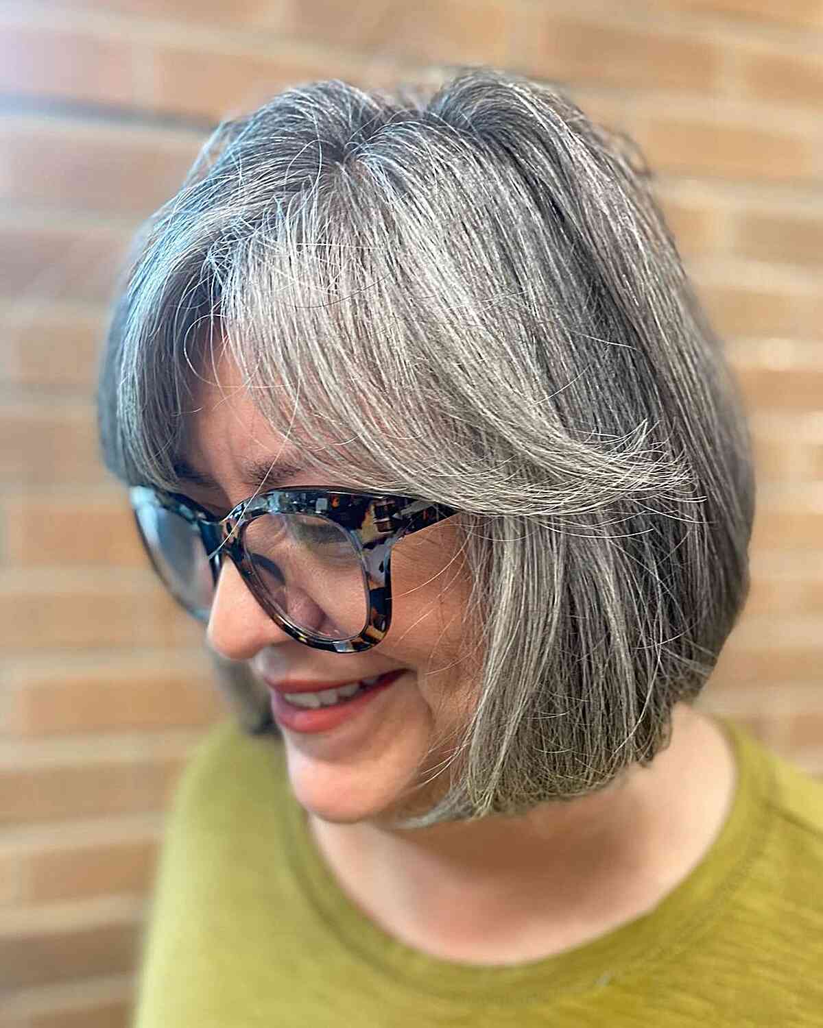 Classic gray bob with feathered bangs for women over 60