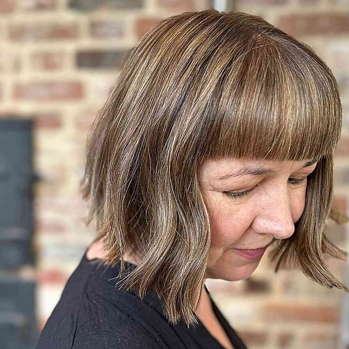 Autumn brown bob with blonde babylights and bangs for ladies aged 60 years