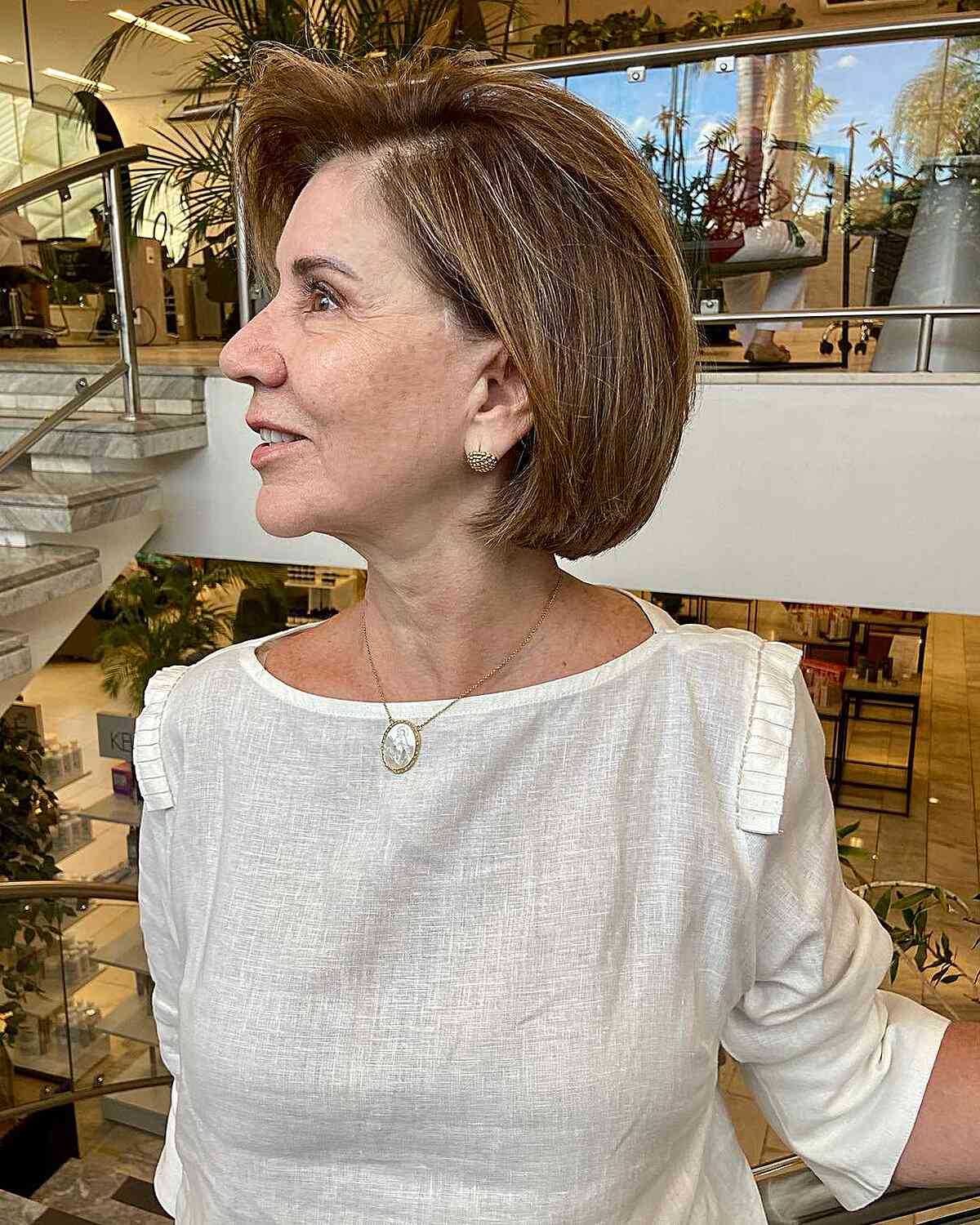 Autumn golden brown haircut on short hair for women 60 years old