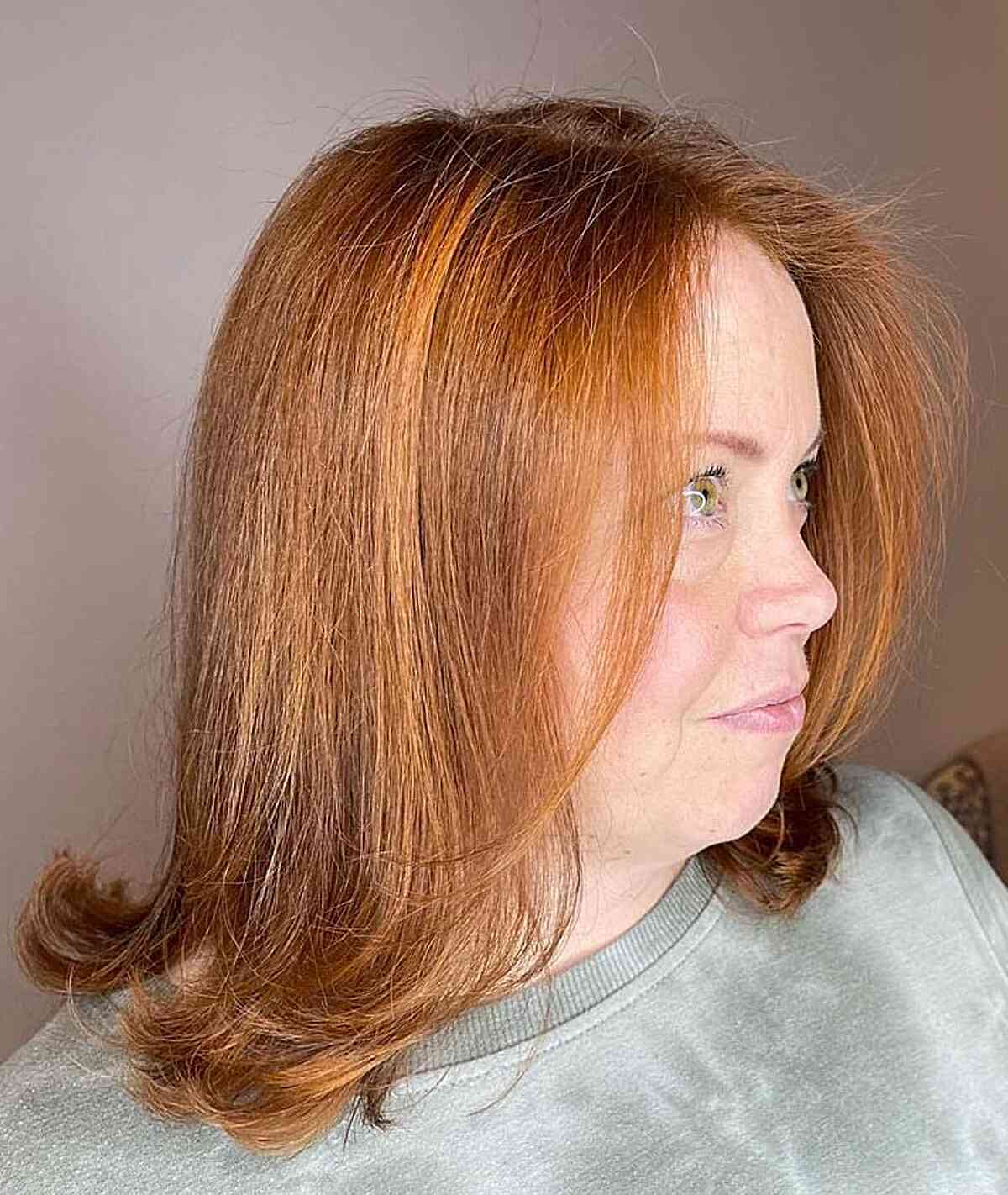 Medium length light copper hair with feathery ends for mature women over 60