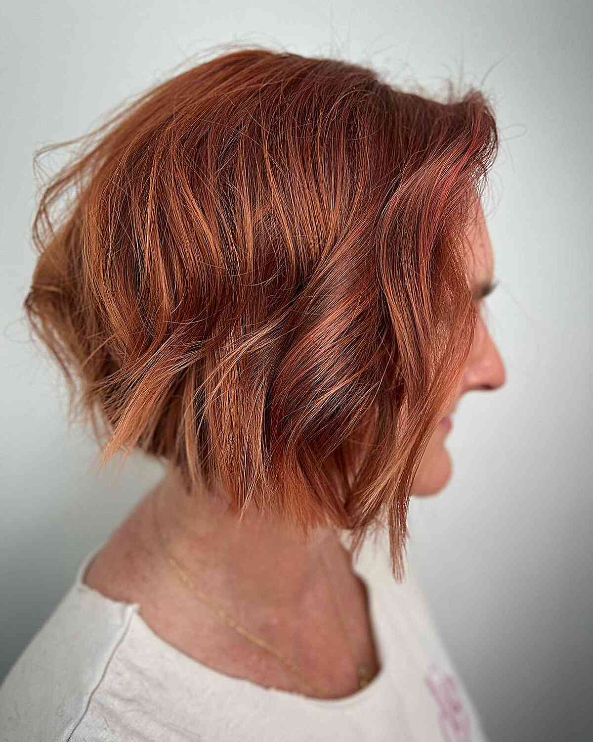 Autumn short bob with coppery red tones for women 60 and over