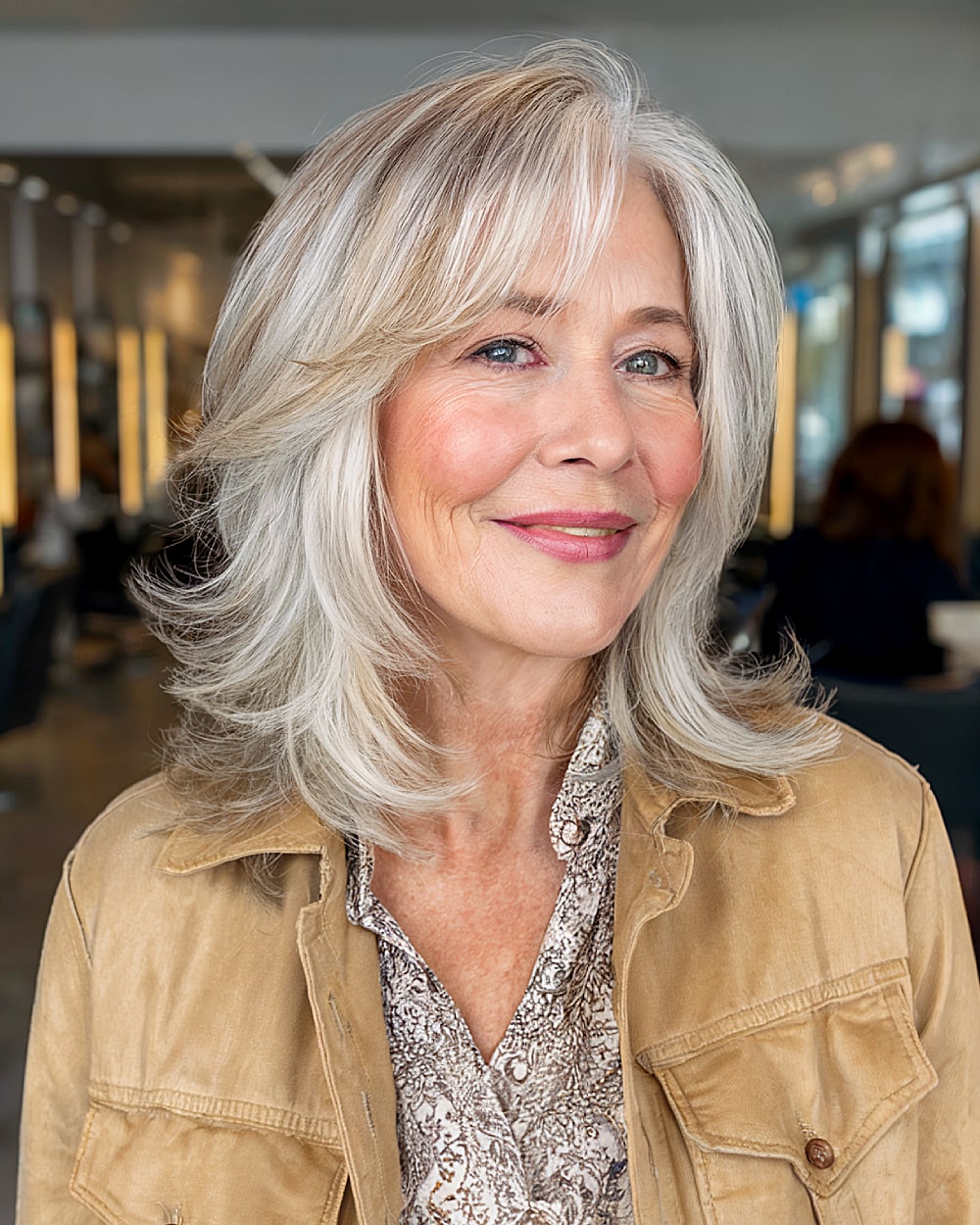 Feathered shoulder length layers with side bangs for women over 60 with silver hair